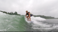 a man surfs the wake on lake arenal
 - Costa Rica