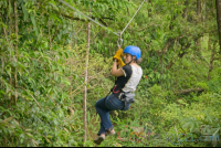 Woman Riding A Zip Line Cable Blue River Zipline Rincon De La Vieja
 - Costa Rica