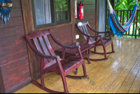 One King Bed Cabanas Corridor With Two Chairs And A Hammock Blue River Resort
 - Costa Rica