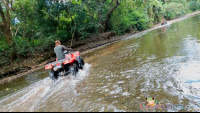 atv nosara tour crossing a creek
 - Costa Rica