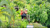 Lady Riding The Cable With A Guide Above The Resort Los Canones Canopy Tour La Fortuna
 - Costa Rica