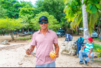 Guide At The Beach Checking In People For The Catamaran Tour
 - Costa Rica