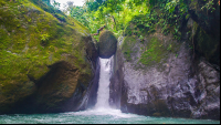 Man Standing On Balanced Rock Of Pavon Waterfall Tour Manuel Antonio
 - Costa Rica