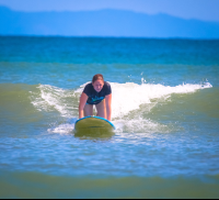 Lady Starting To Stand On Board Pollo Surf School Matapalo
 - Costa Rica