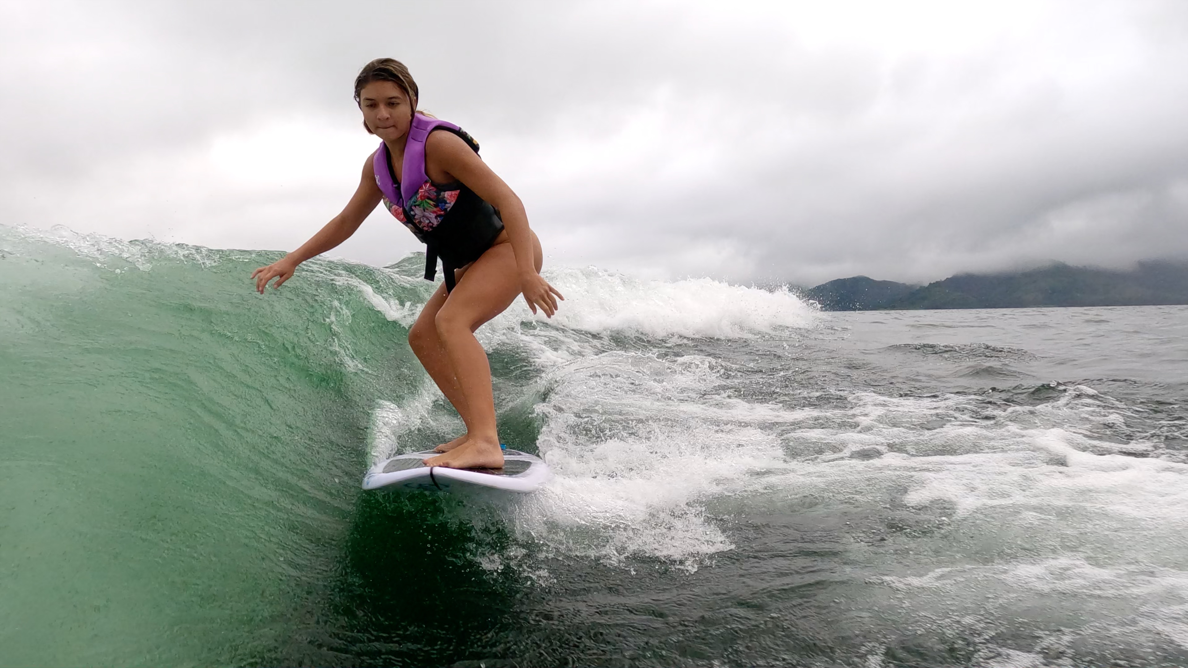 a young lady wakesurfs on lake arenal.jpg