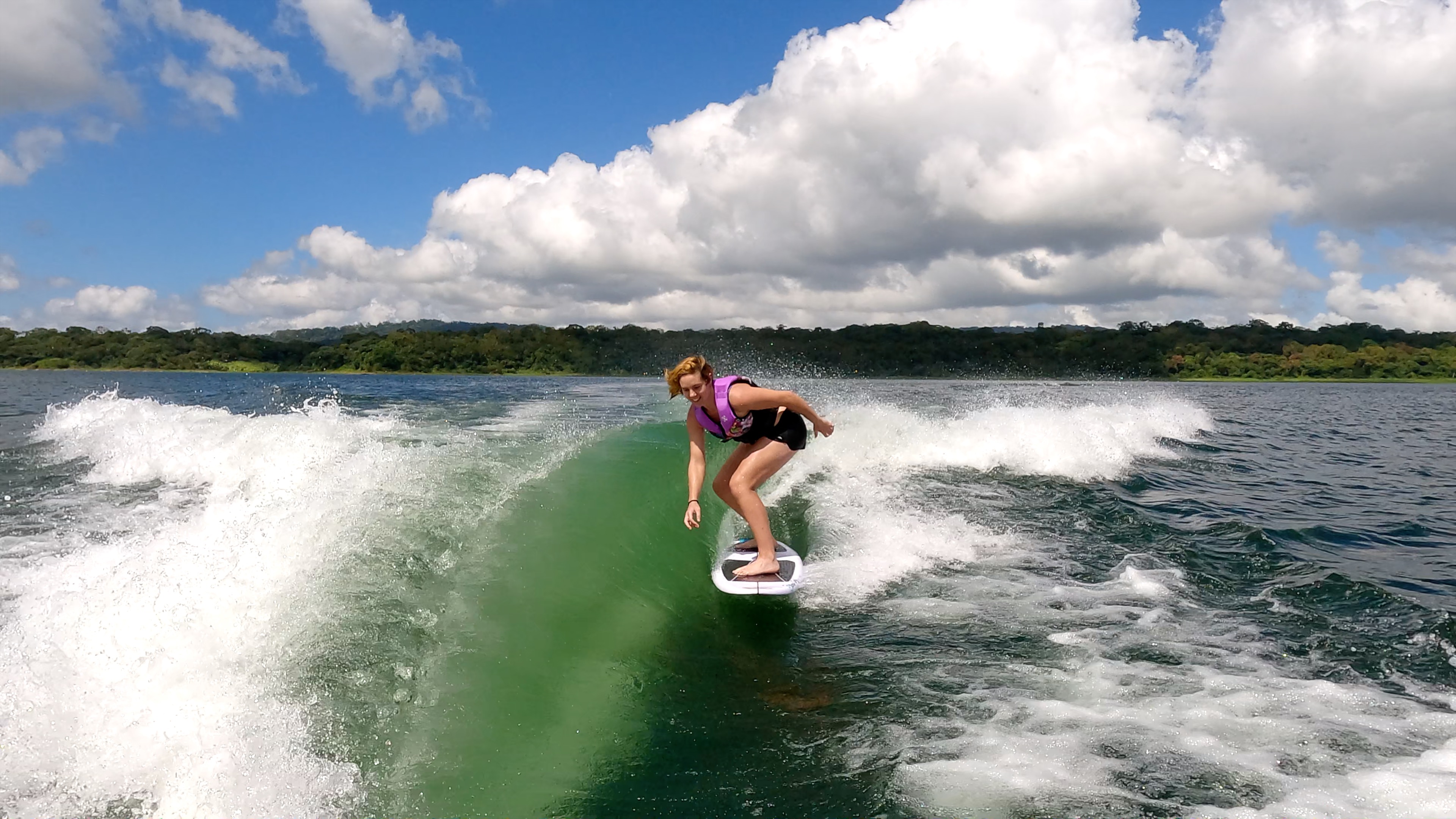 a woman wakesurfing on a sunny day on lake arenal.jpg