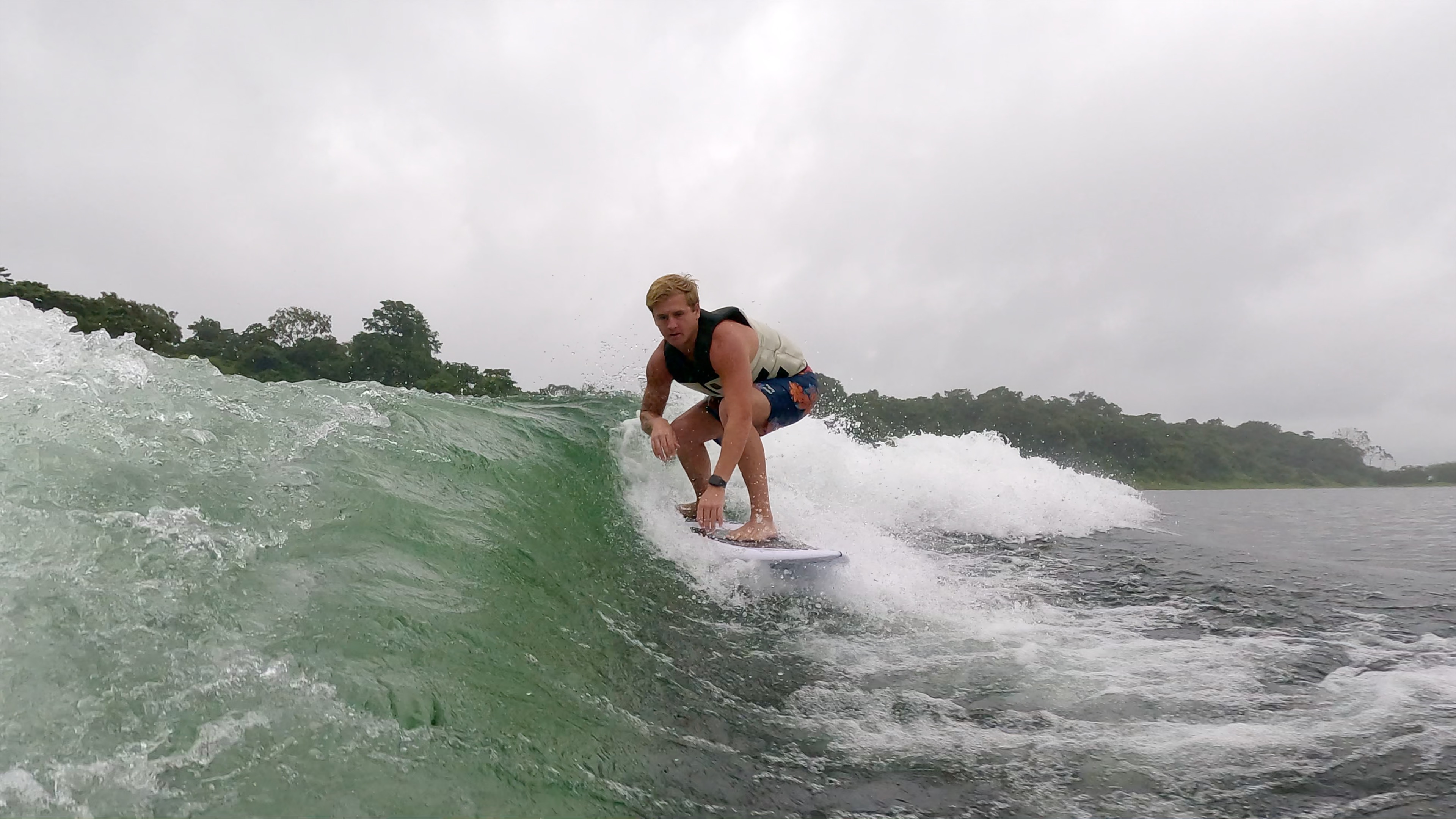 a man surfs the wake on lake arenal.jpg