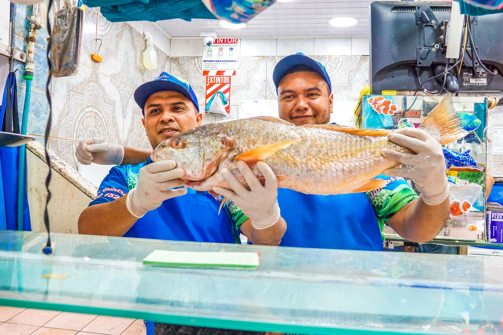 Vip City Tour Men Holding A Fish At Central Market