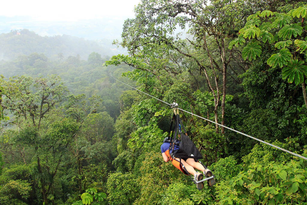 A visitor rides a zip line on the Superman de Osa tour