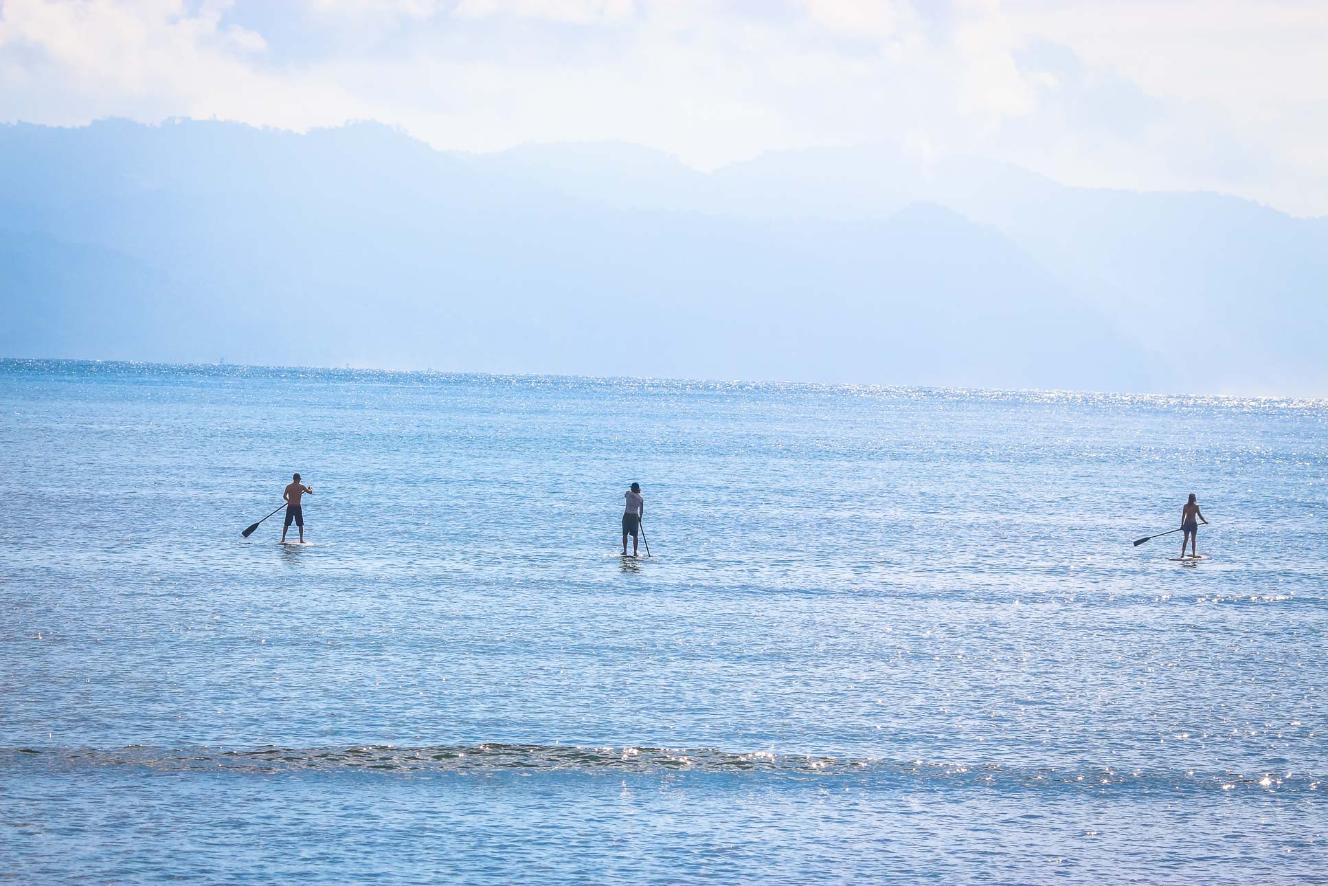 Three People Suping On Pan Dulce Beach