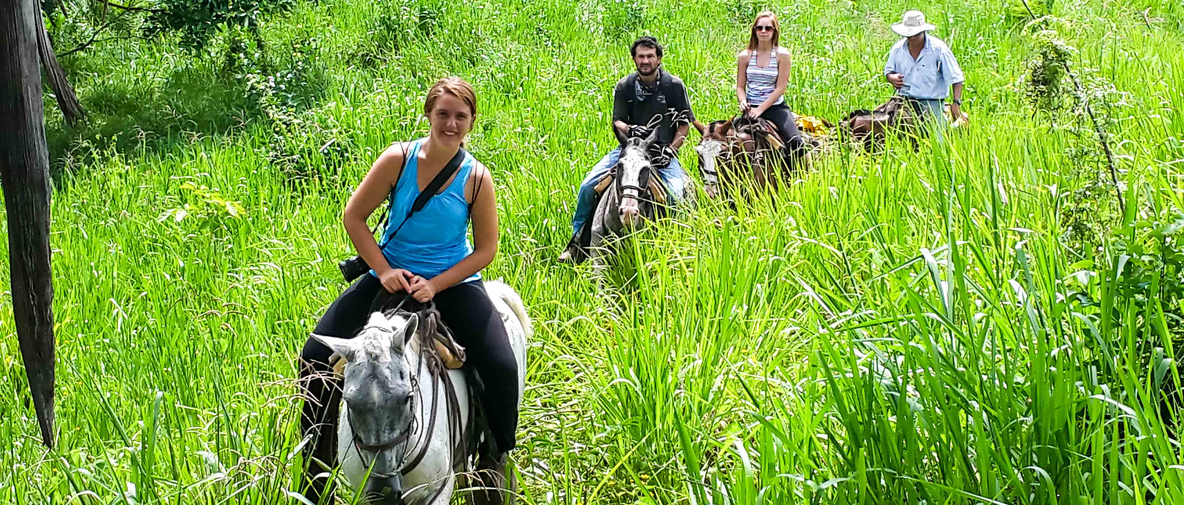 Horseback Riders Going Up A Hill