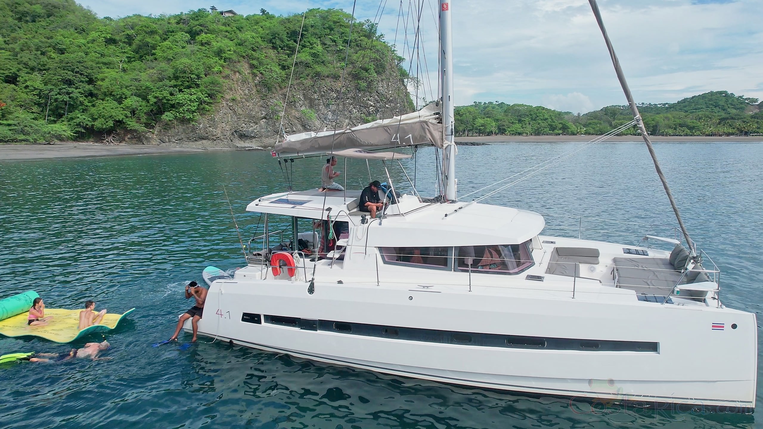 lateral view with people snorkeling and playing in the water 41 foot luxury charter catamaran guanacaste.jpg
