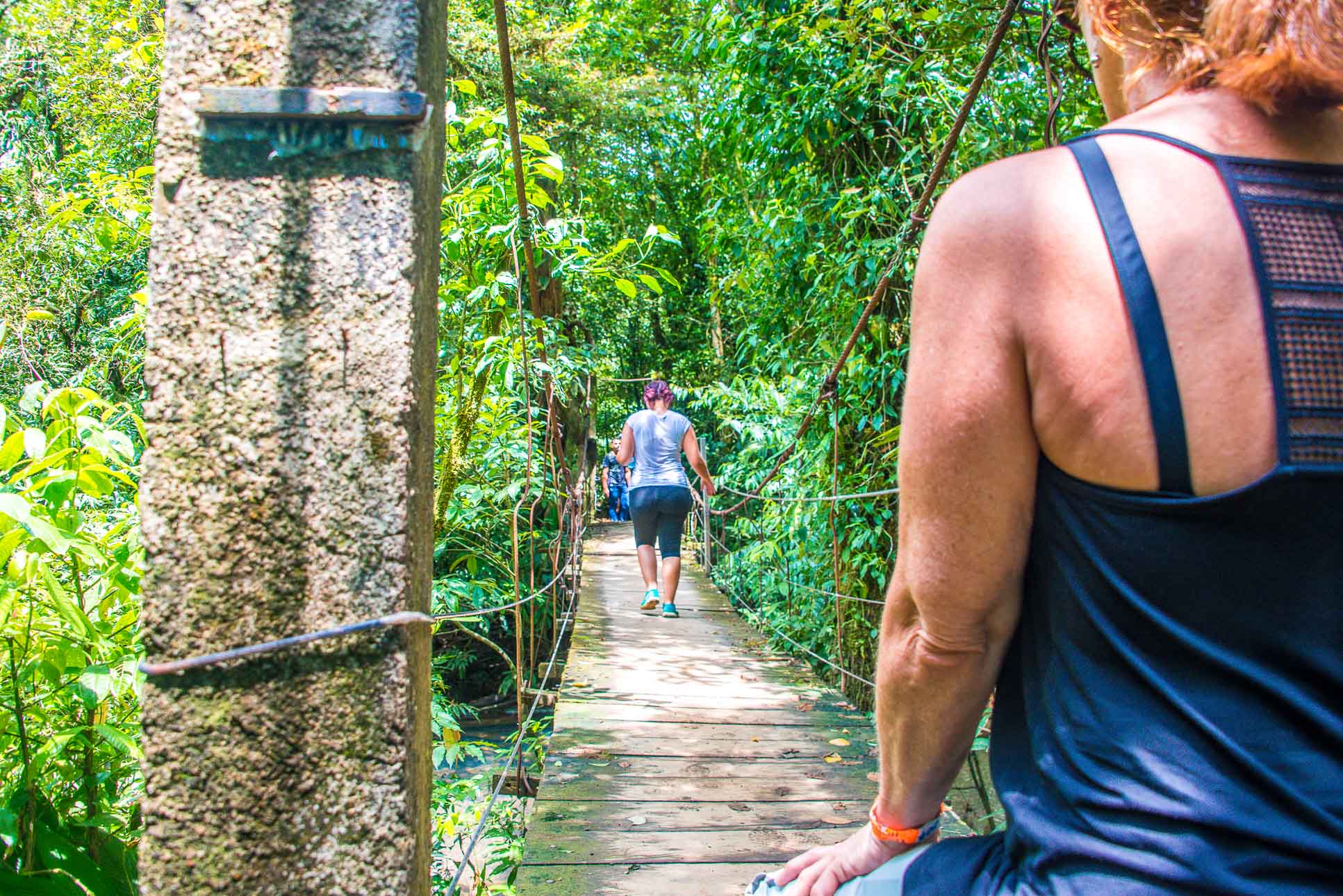 People Crossing The Celeste River Hanging Bridge