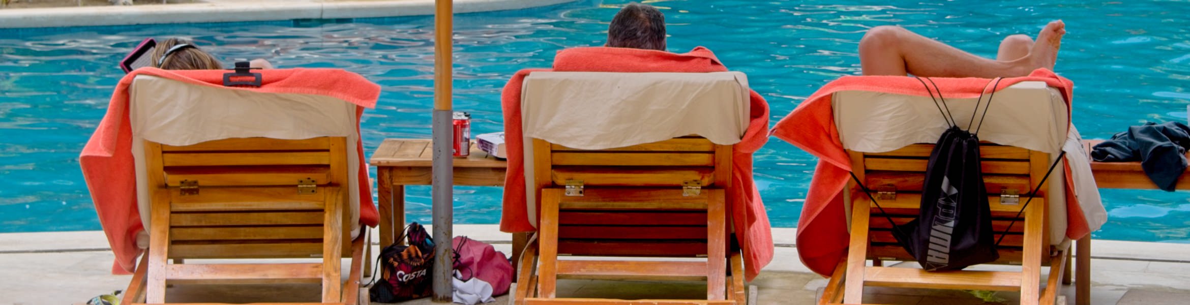 people enjoying life laying on bathing benches by the pool.jpg