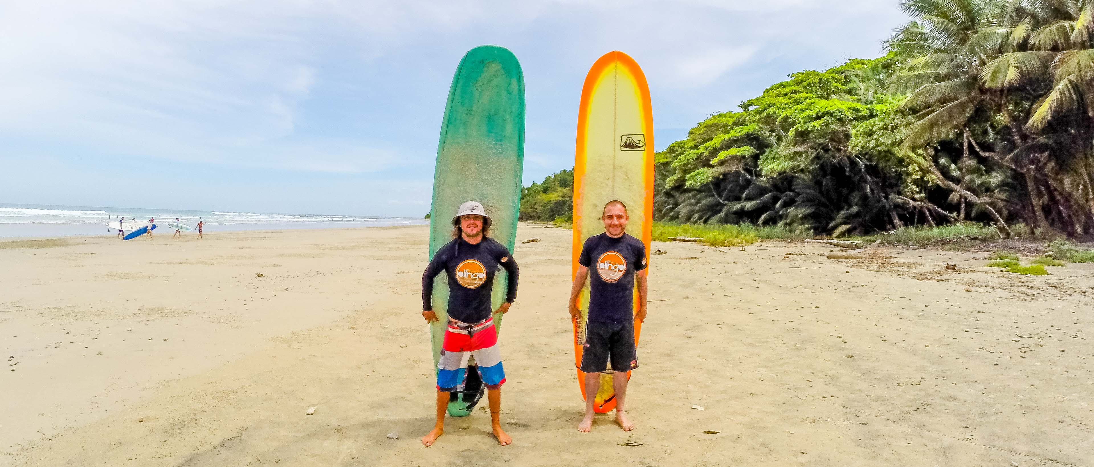 Olingo Tours Surf Lesson Students Holding Board
