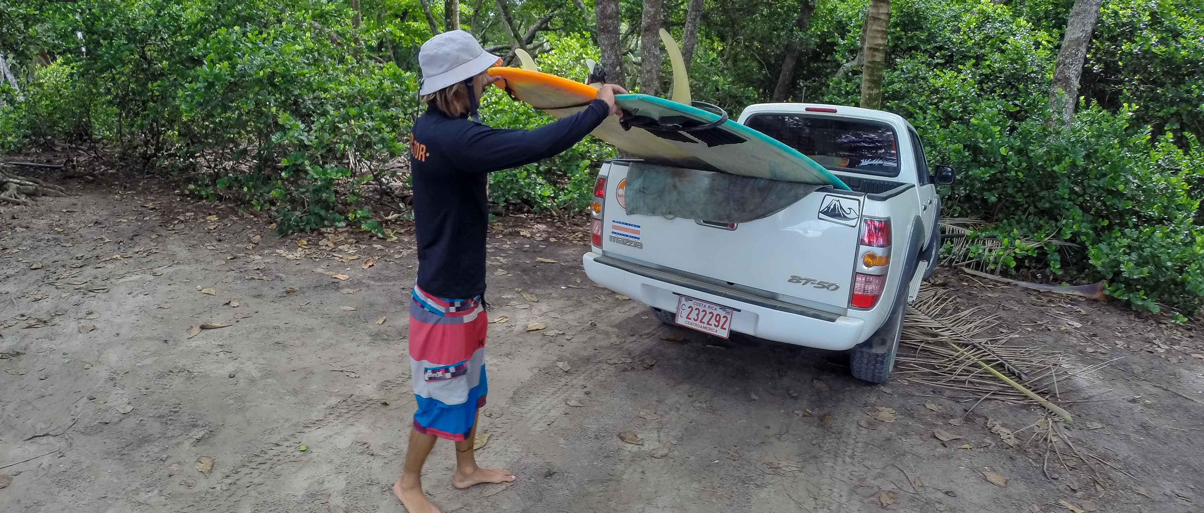 Surfer Instructor Unloading Surf Boards